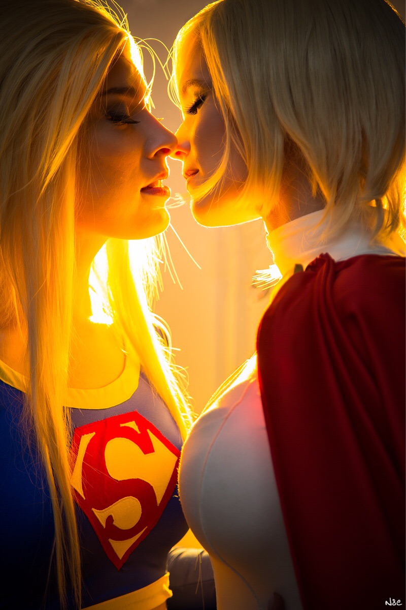 Supergirl and Power Girl about to kiss.