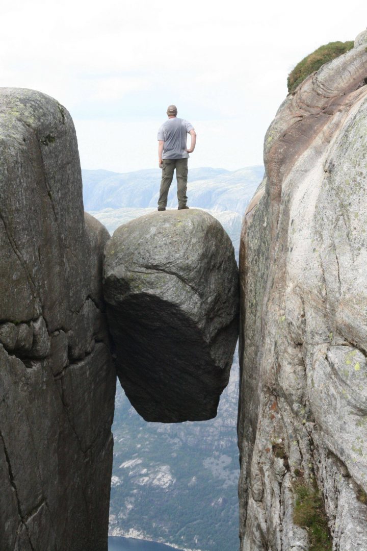 stuffofawesome-oh-just-standing-on-a-boulder-stuck-between-two-cliffs-3000-feet-above-the-fjord-below-1313622006-701